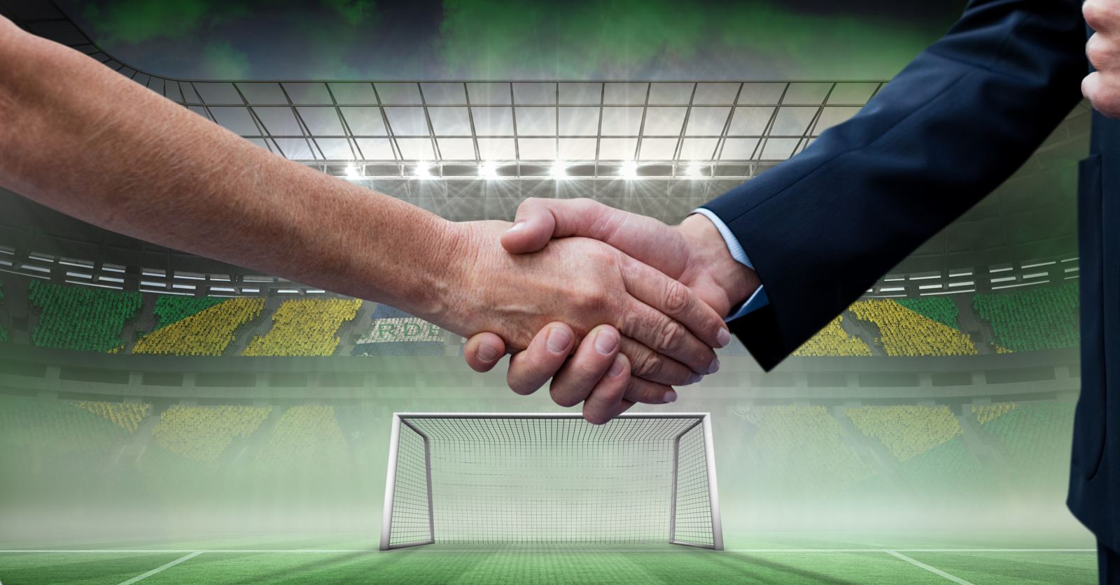 Zakelijke handdruk met een stadion op de achtergrond